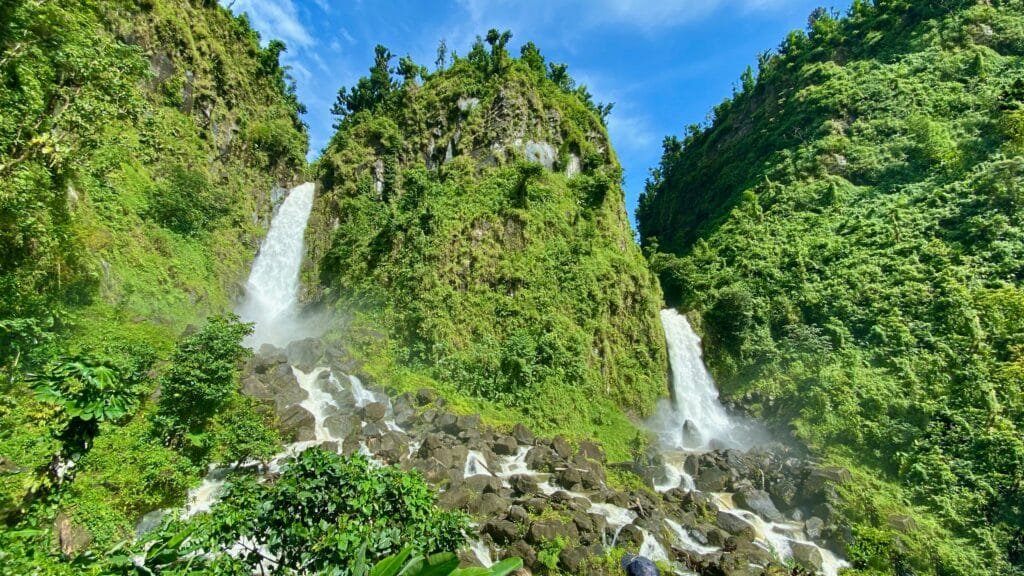 Vista da cachoeira de Trafalgar Falls, Dominica, durante o dia com árvores em volta. 